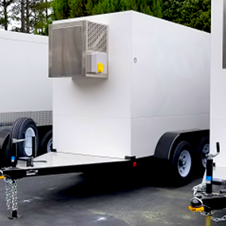 A white box on wheels with a trailer attachment