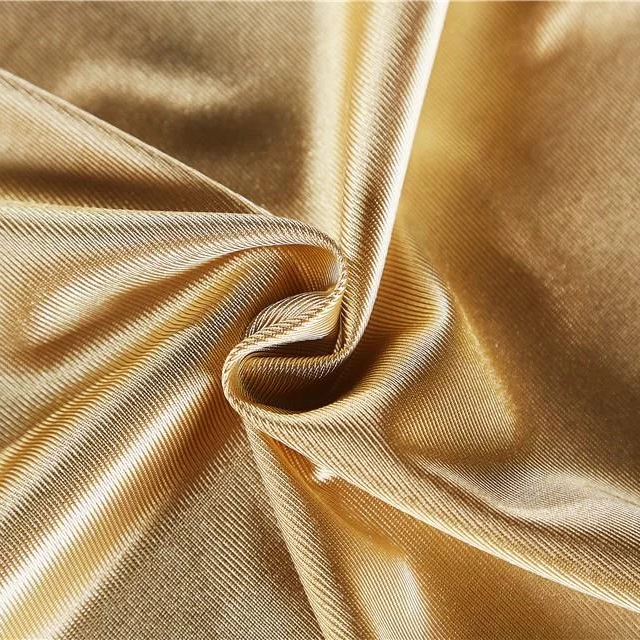 A close up of bunched up gold, shiny fabric
